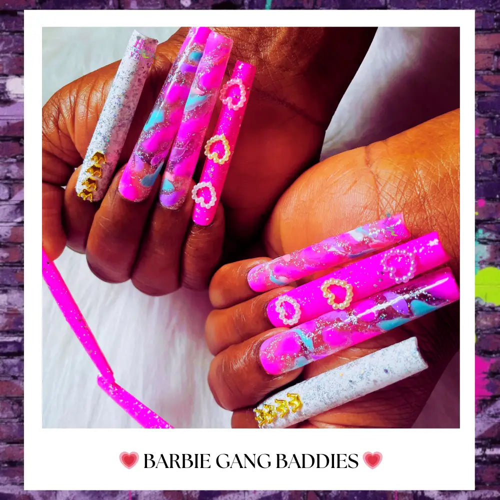 long pink press-on nails with pink glitter transparent background marble designs, heart accents, and golden crowns on white glitter accent nail