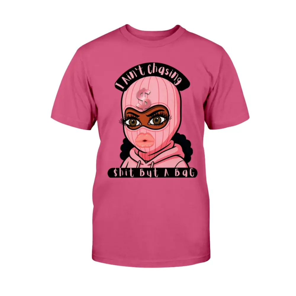 “Pink t-shirt with cartoon baddie wearing a pink ski mask and hoodie, with text reading ‘I Ain’t Chasing Shit But a Bag’ in black and pink.”