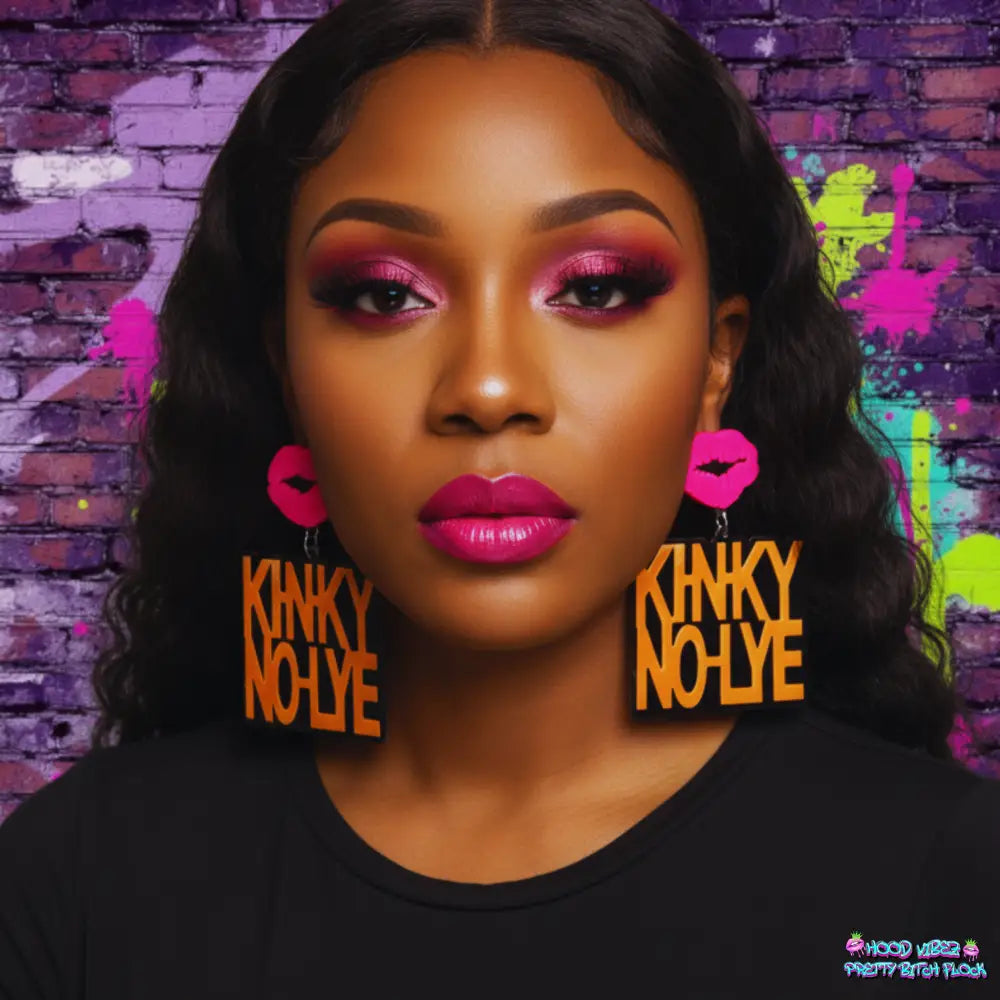 Kinky No Lie statement earrings featuring bold gold lettering with hot pink lip accents on a black background.