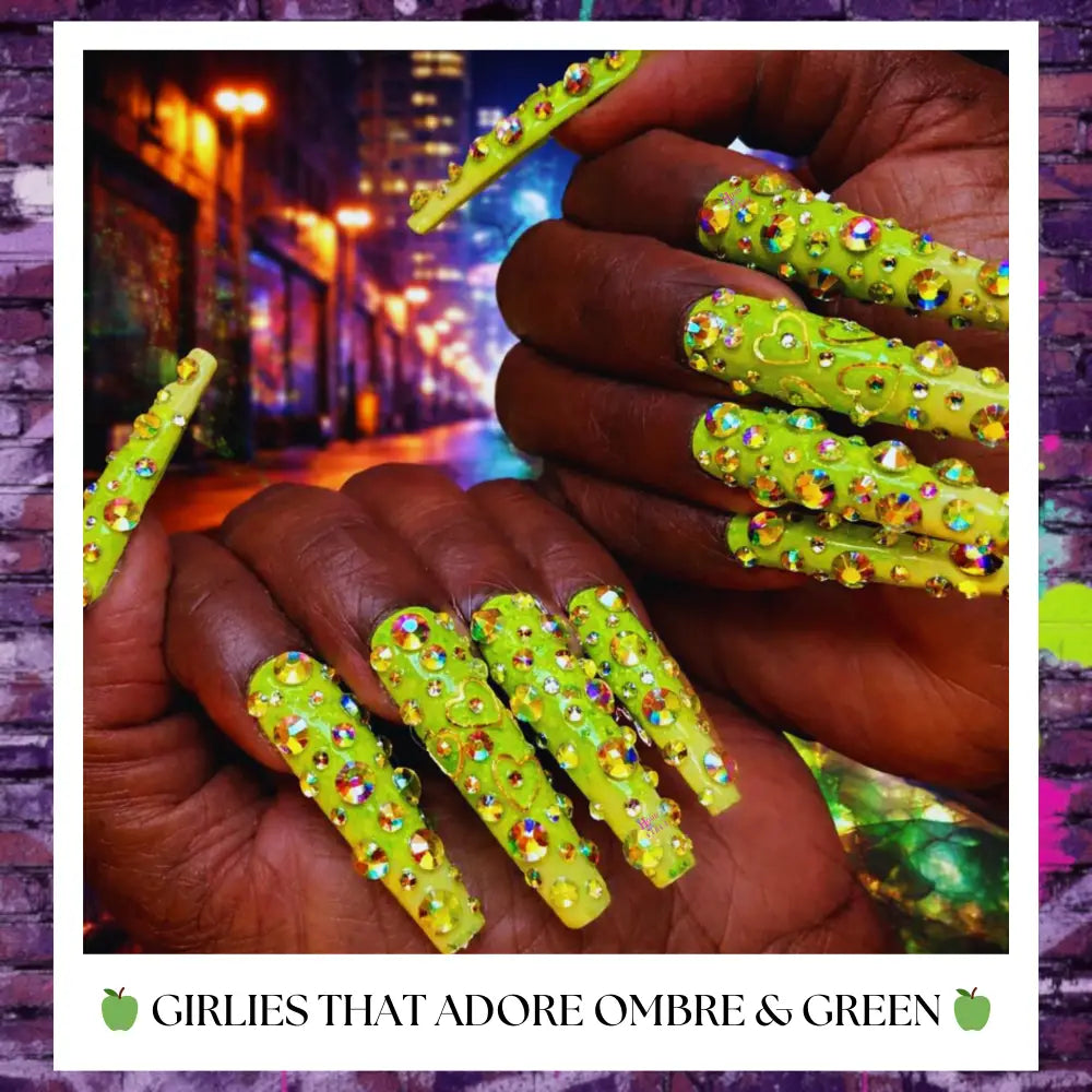Neon green coffin press-on nails fully covered in rhinestones with heart accents on dark skin hands, styled with a bold urban aesthetic background.
