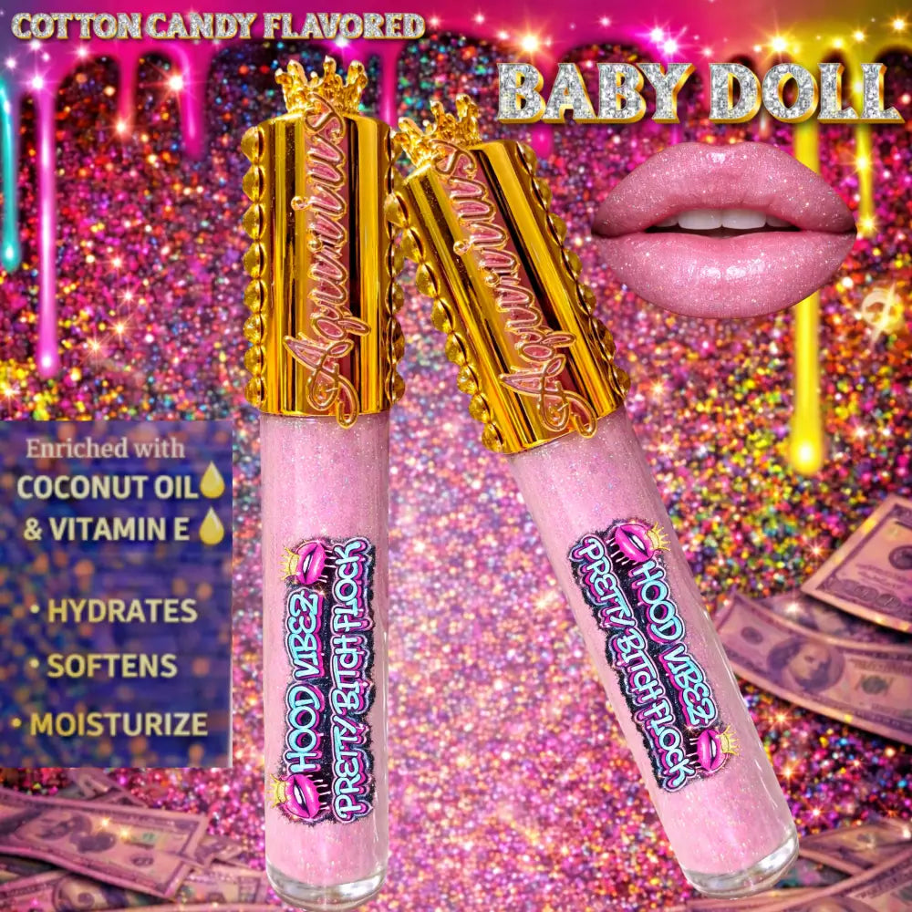 Baby Doll pigmented baby pink glitter lip gloss with cotton candy flavor, enriched with coconut oil and vitamin E, displayed in luxury gold lip gloss tubes against an urban graffiti money background.
