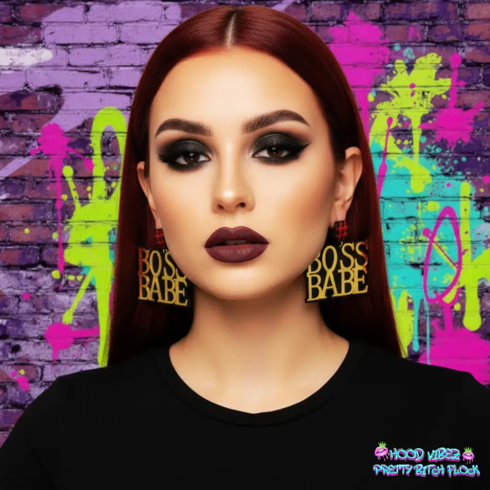 Boss Babe statement earrings featuring bold gold lettering with red hashtag accents on a dark background.