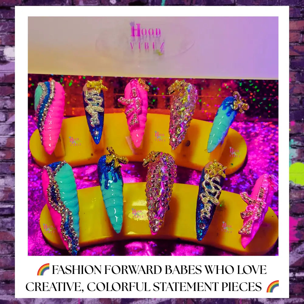 “Bougie Ballerina press on nails in pink and turquoise with snakeskin texture, rhinestones, gold charms, and glossy coffin shape,”
