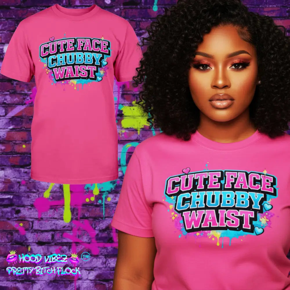 Pink t-shirt with 'Cute Face Chubby Waist' text worn by a model against a colorful brick wall.