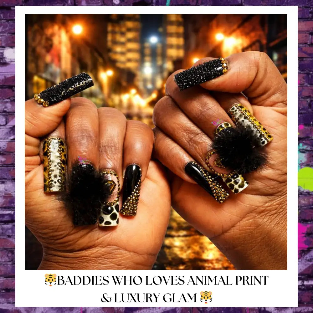 Close-up of hands wearing Midnight Hustle Drip press-on nails featuring glossy black bases, gold rhinestone accents, animal print details, plush black charm embellishments, and mixed textured finishes in a luxury urban style.