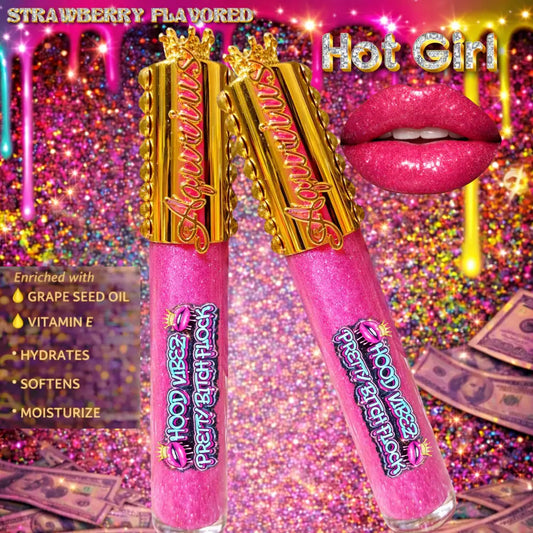 Hot Girl strawberry flavored pigmented glitter lip gloss in baby pink shade infused with grape seed oil and vitamin E displayed in luxury gold lip gloss tubes with urban glam background.