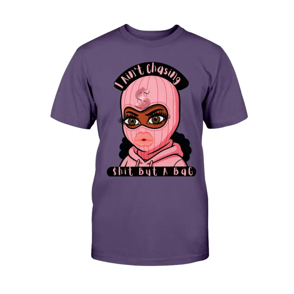 “Purple t-shirt with cartoon baddie wearing a pink ski mask and hoodie, with text reading ‘I Ain’t Chasing Shit But a Bag’ in black and pink.”
