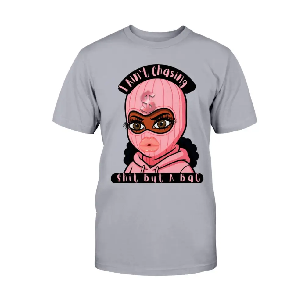 “Gray t-shirt with cartoon baddie wearing a pink ski mask and hoodie, with text reading ‘I Ain’t Chasing Shit But a Bag’ in black and pink.”