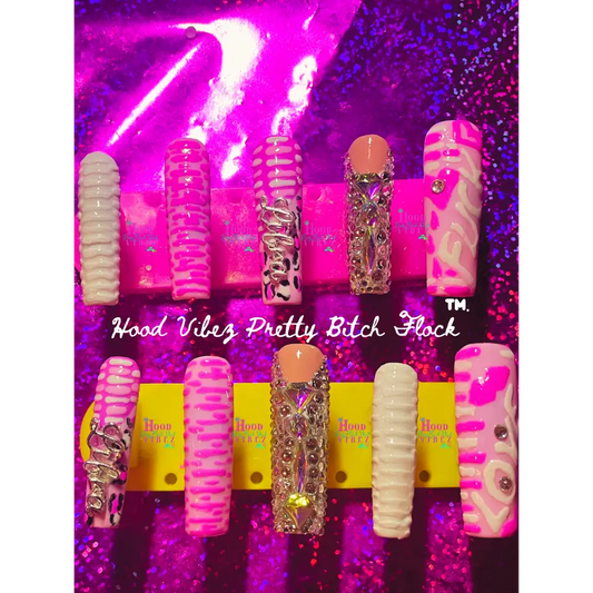 A set of long square press on nails with chaotic rippled and zig-zag designs, featuring two rhinestone nails, displayed on a leopard print background.