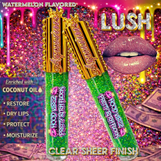Green glitter-infused lip gloss tubes with gold caps displayed on an urban graffiti background, highlighting a coconut oil–enriched, high-shine lip gloss for hydrated, glossy lips.