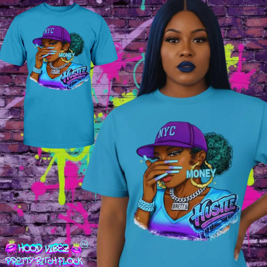 Woman wearing a blue t-shirt with a graphic design of a person in a purple NYC hat and 'Hustle' text, against a colorful graffiti brick wall.