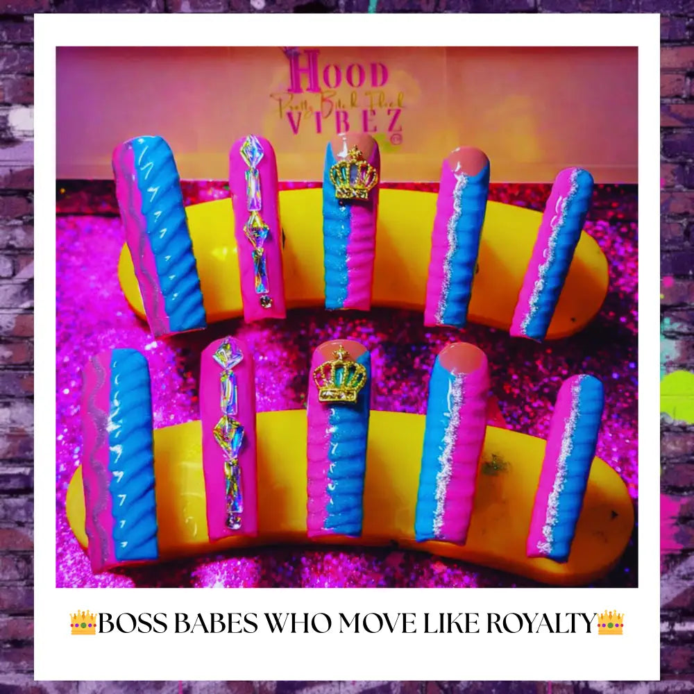 Luxury press on nails featuring pink and teal drip designs with gold crown charms and crystal accents, displayed on a glittery background for a bold, high-glam manicure look.