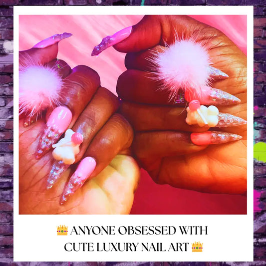 Close-up of handcrafted pink glitter press-on nails shaped like ice cream cones, pink fluffy pom poms and white gummy bears with lollipops on accent nails. 