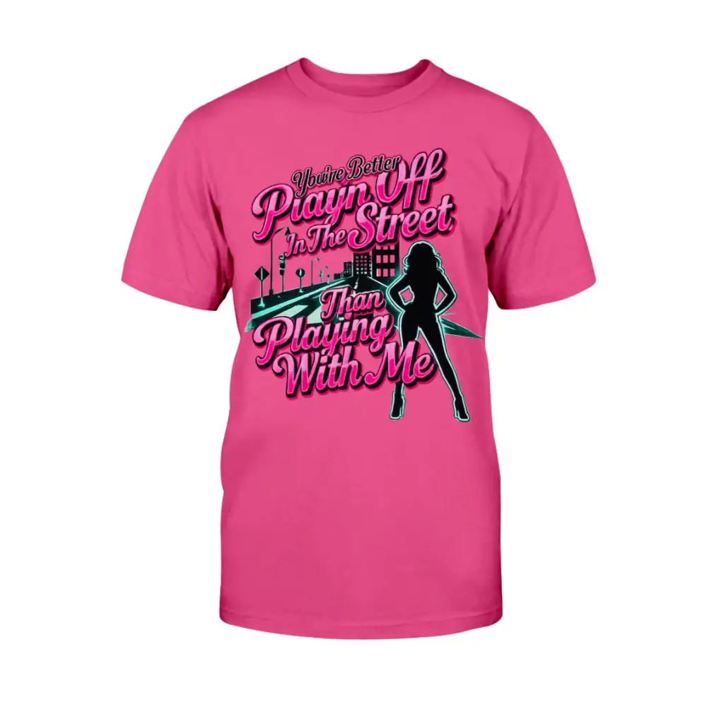 Pink graphic t-shirt featuring bold pink statement text “You’re Better Playin’ In The Street Than Playing With Me” with urban city background and female silhouette design by Hood Vibez Pretty Bitch Flock.