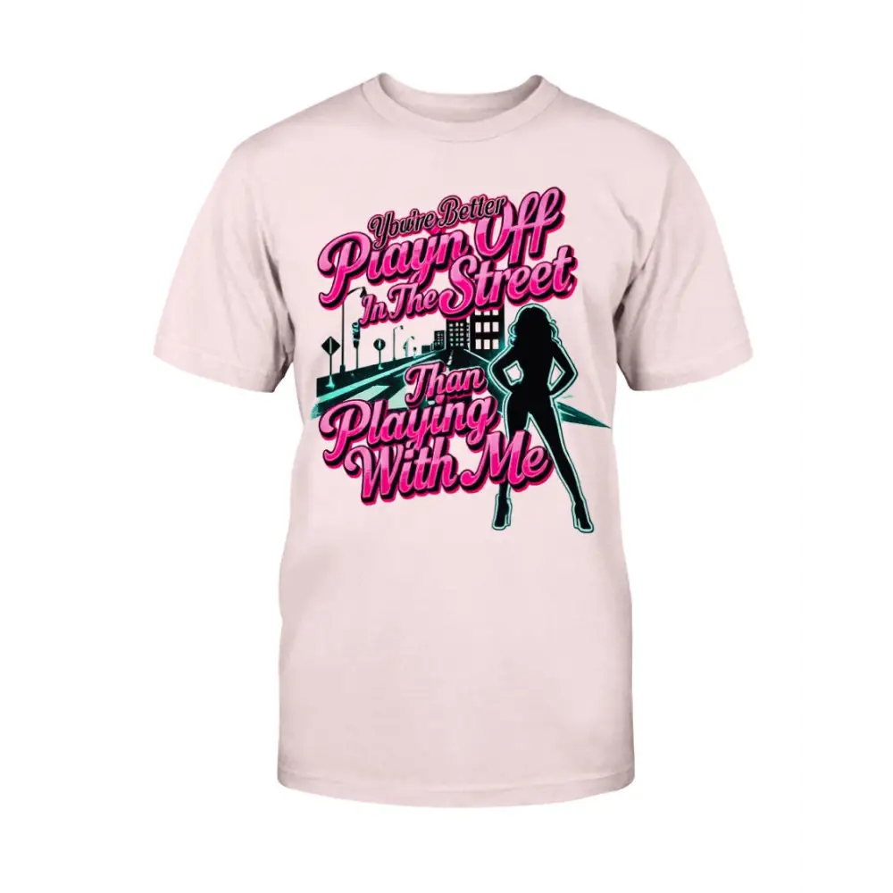 Light pink graphic t-shirt featuring bold pink statement text “You’re Better Playin’ In The Street Than Playing With Me” with urban city background and female silhouette design by Hood Vibez Pretty Bitch Flock.