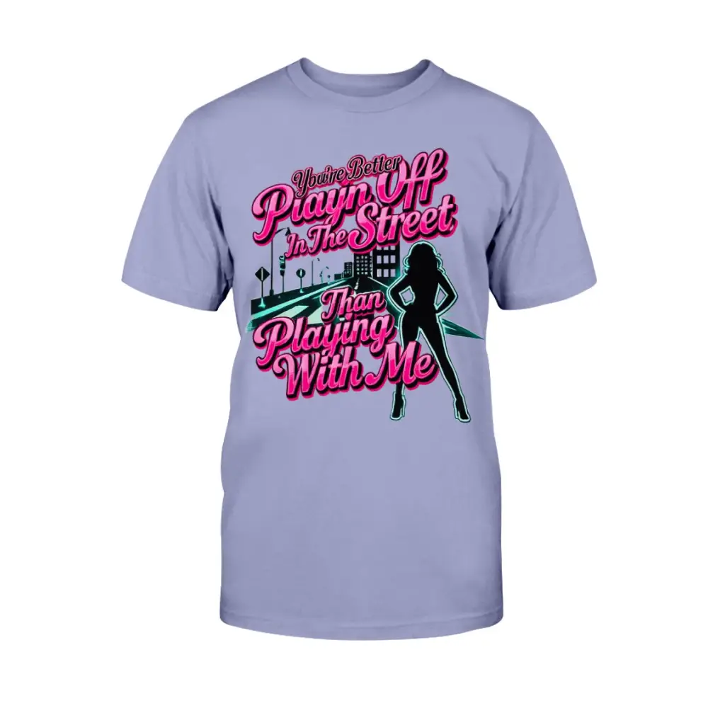 Lavender graphic t-shirt featuring bold pink statement text “You’re Better Playin’ In The Street Than Playing With Me” with urban city background and female silhouette design by Hood Vibez Pretty Bitch Flock.