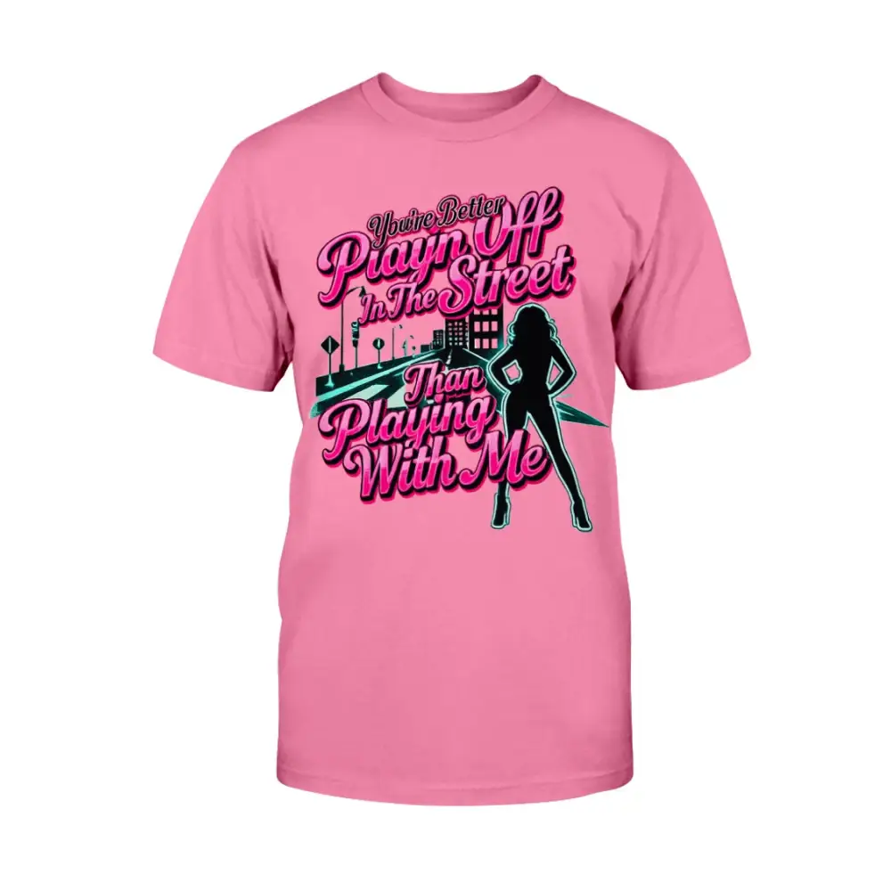Pink graphic t-shirt featuring bold pink statement text “You’re Better Playin’ In The Street Than Playing With Me” with urban city background and female silhouette design by Hood Vibez Pretty Bitch Flock.