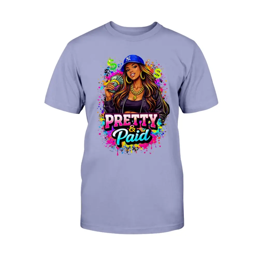 Pretty & Paid graphic t-shirt featuring urban boss babe holding cash, colorful street art background, and bold statement lettering on lavender tee.