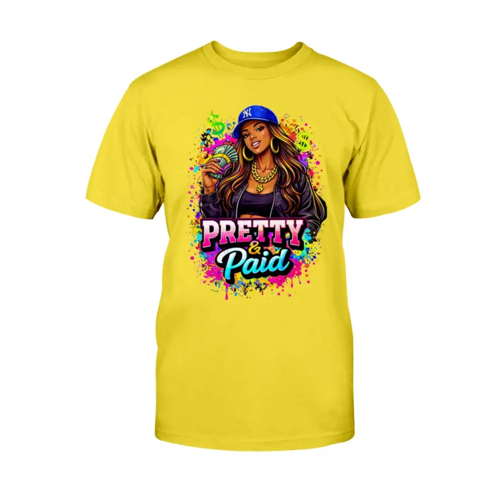 Pretty & Paid graphic t-shirt featuring urban boss babe holding cash, colorful street art background, and bold statement lettering on yellow tee.