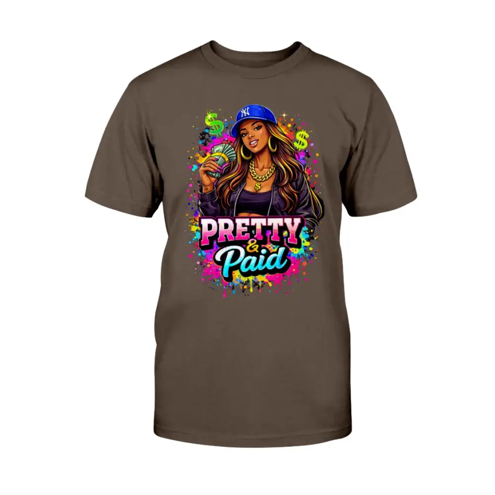 Pretty & Paid graphic t-shirt featuring urban boss babe holding cash, colorful street art background, and bold statement lettering on brown tee.