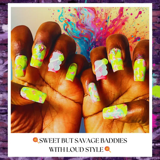 Close-up of Tropical Cyclone press on nails featuring neon green and pink swirl designs with glossy finish and candy-inspired accent charms on hands against a colorful abstract background.