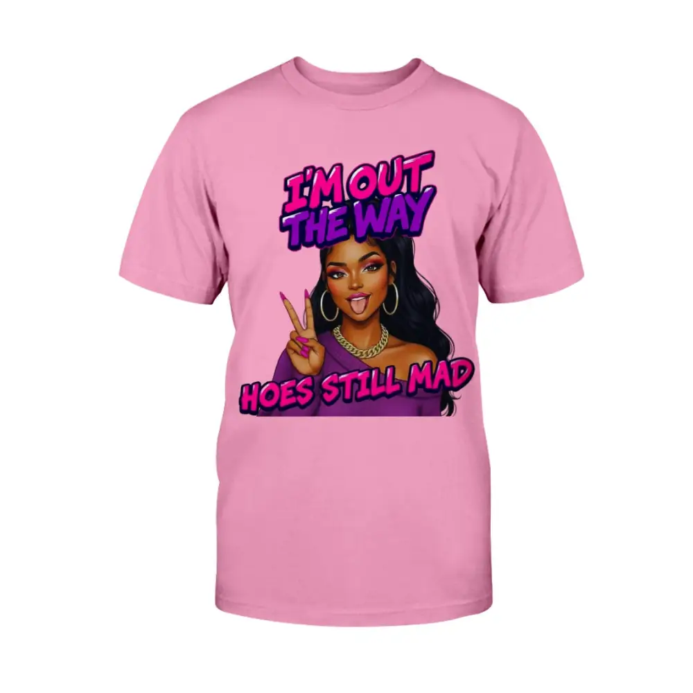 A pink women's t-shirt featuring a cartoon-style Black woman with long hair, hoop earrings, gold chain, and pink nails flashing a peace sign, with bold pink and purple text that reads “I’m Out the Way, Hoes Still Mad.”"